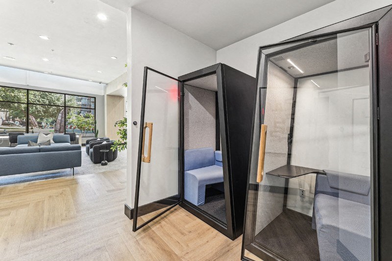 a glass elevator shaft in a living room with glass doors