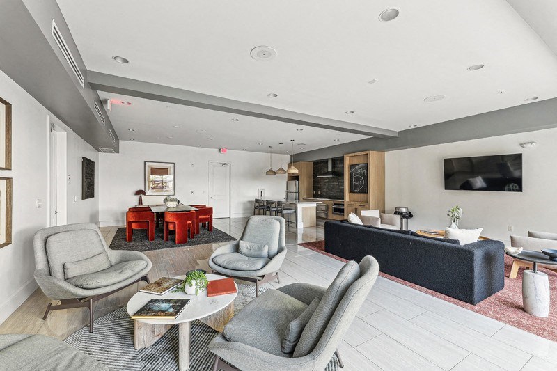 a living room with couches and chairs and a television