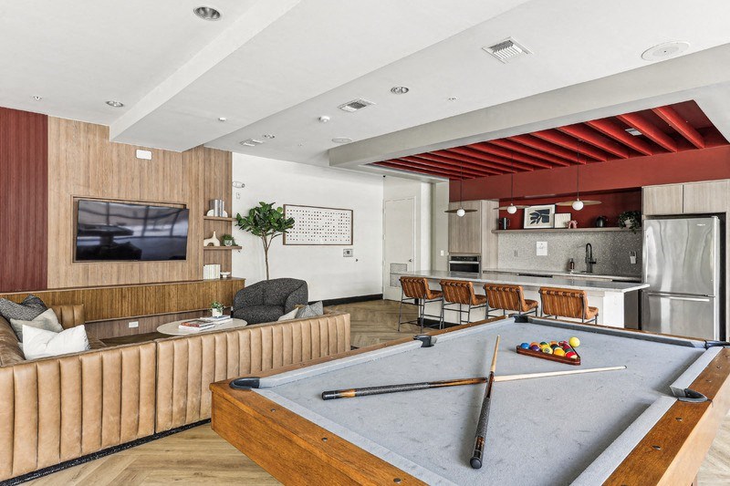 a game room with a pool table and a tv