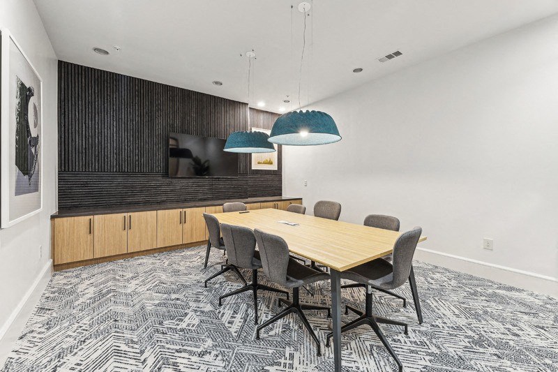 a conference room with a wooden table and chairs