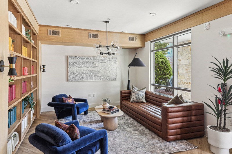 a living room with leather furniture and a large window