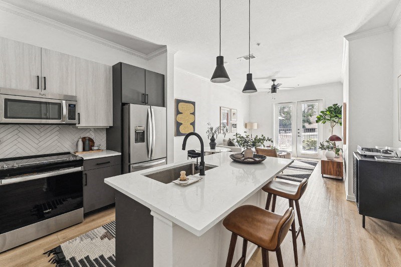 a kitchen with a large island and a black and white