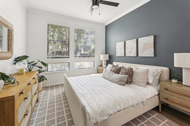 a bedroom with a bed and a ceiling fan