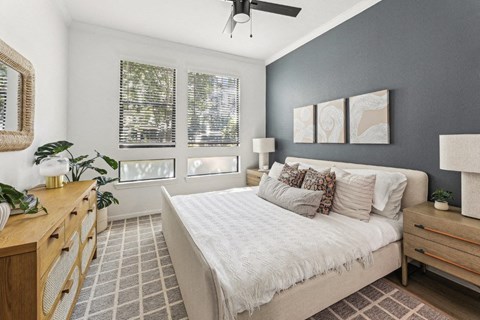 a bedroom with a bed and a ceiling fan
