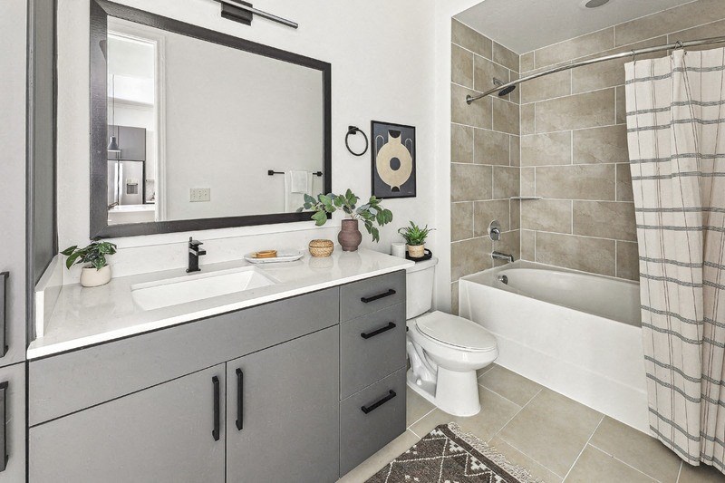 a bathroom with a sink and a toilet and a bath tub