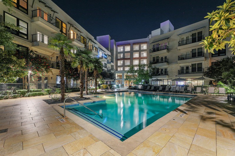the swimming pool at night at the grove apartments