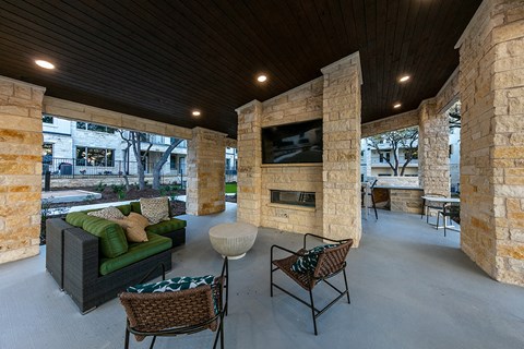 a large patio with furniture and a tv on the wall