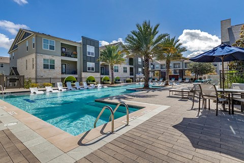 our apartments offer a swimming pool with chairs and umbrellas