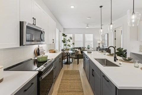 A modern kitchen with a black stove top oven and a microwave above it.