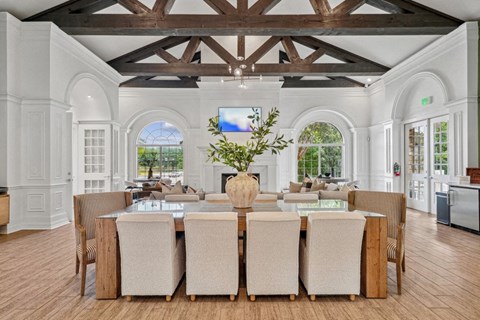 a large dining room with a table and chairs