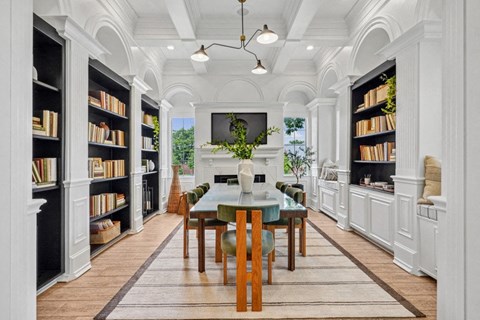 a dining room with white cabinets and a table and chairs