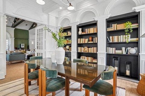 a dining room with a table and chairs and a library