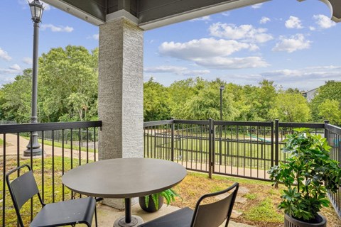 a patio with a table and chairs on a balcony
