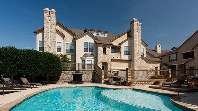 A large house with a pool in front.