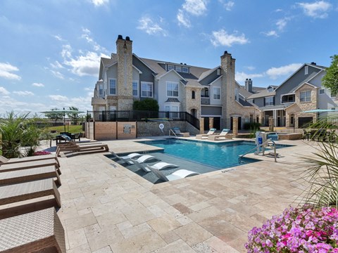A large house with a pool in the backyard.