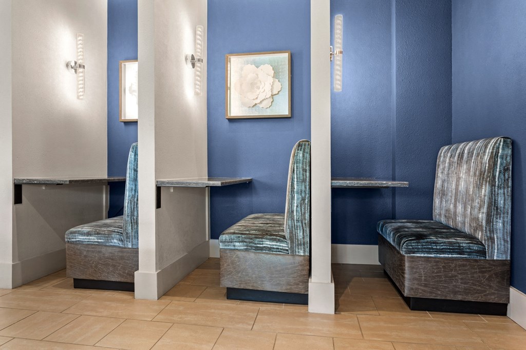 two chairs in a room with a table and two mirrors