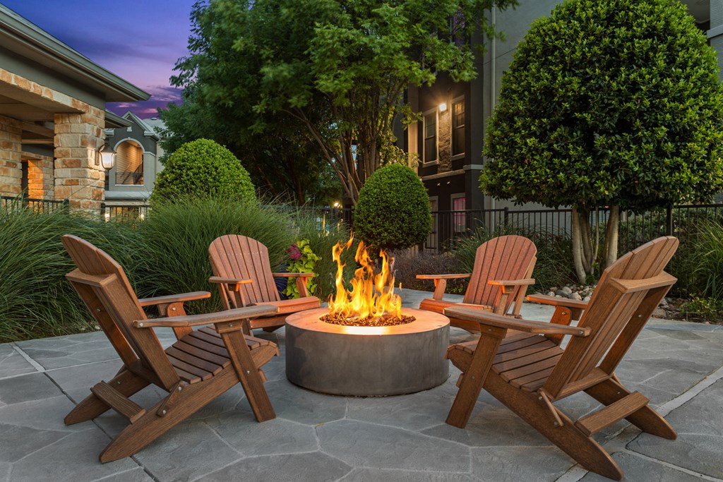 a fire pit with chairs around it on a patio