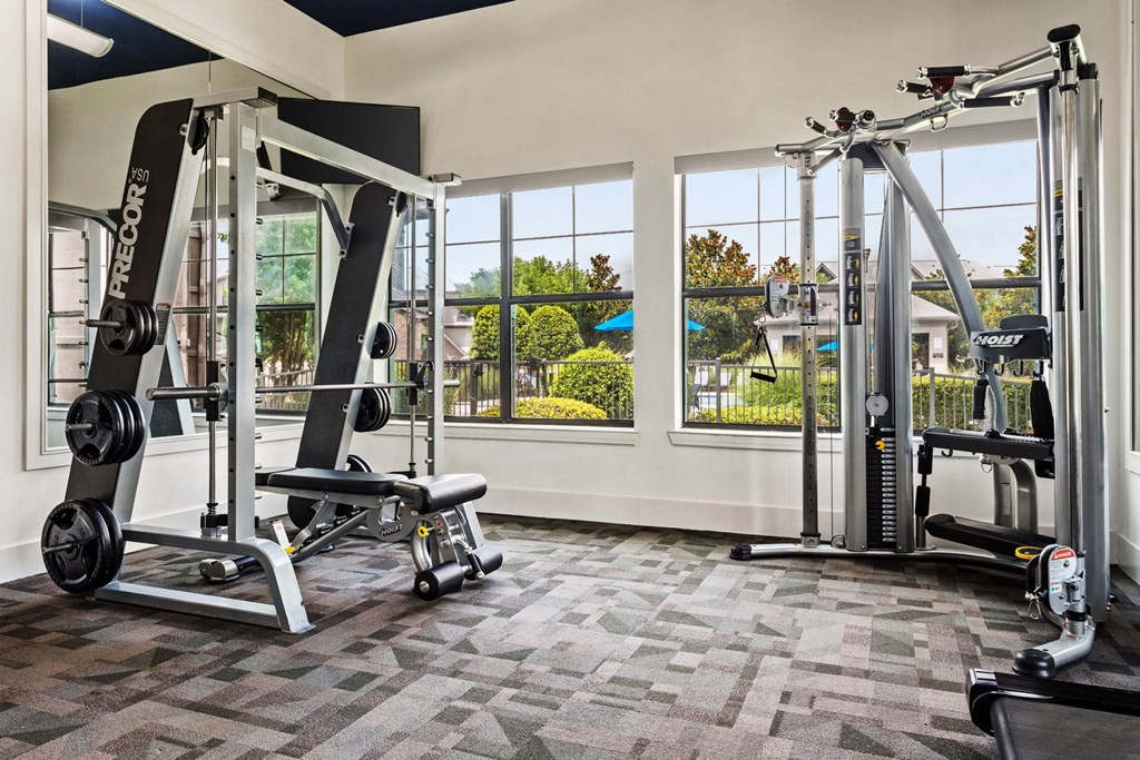a home gym with weights and a view of the outdoors