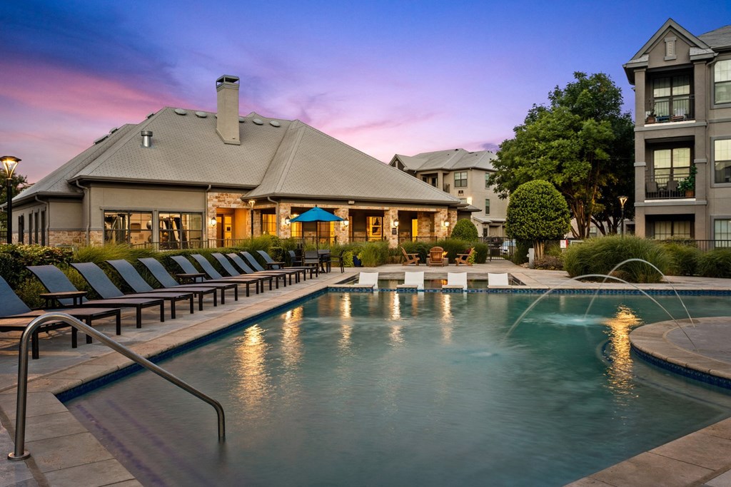 a swimming pool with a building in the background