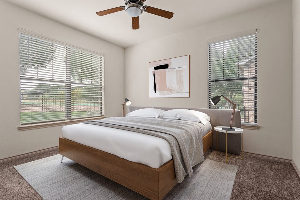a bedroom with a bed and a ceiling fan