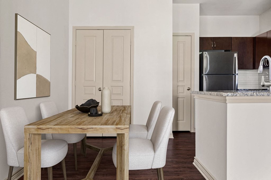 a kitchen and dining room with a table and chairs