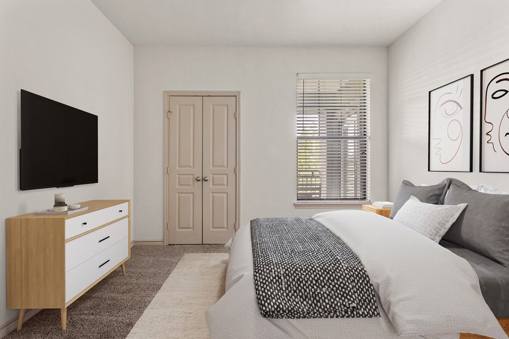 a bedroom with a large bed and a tv