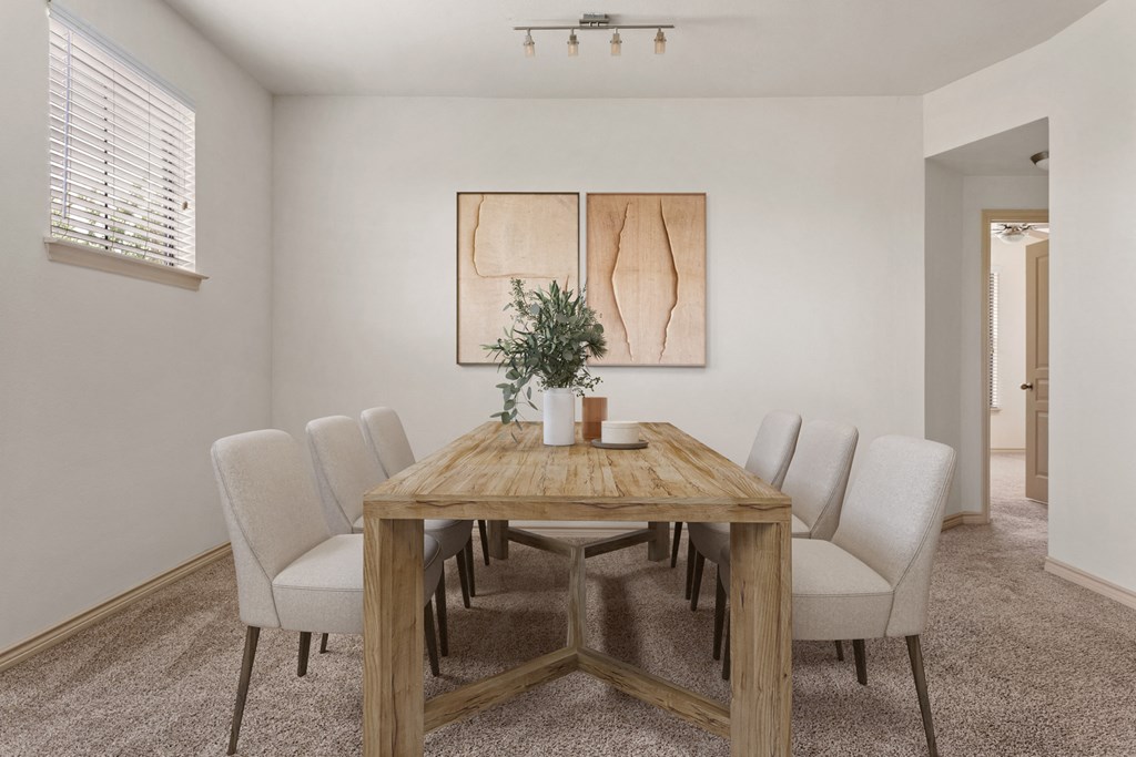 a dining room with a wooden table and white chairs