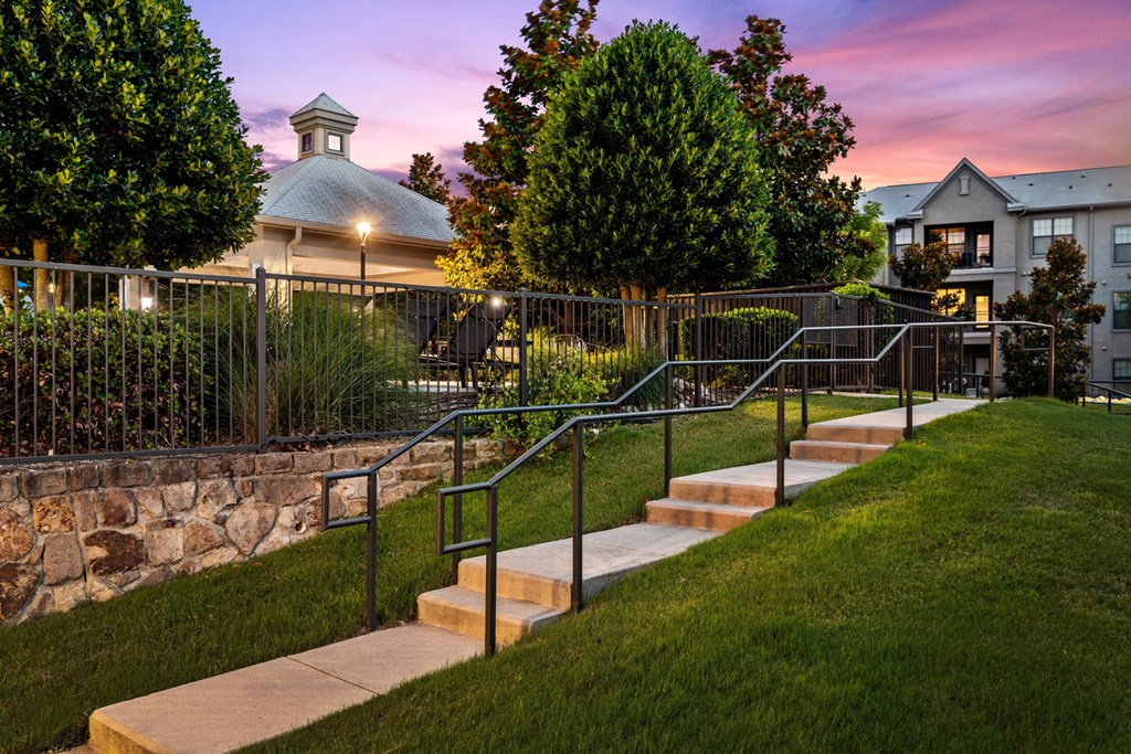 a set of steps leading up to a yard with a house in the background
