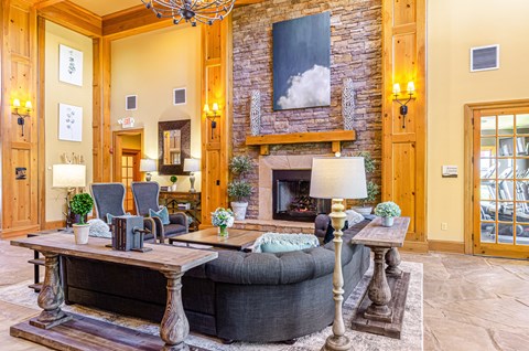 a living room with a large couch and a fireplace