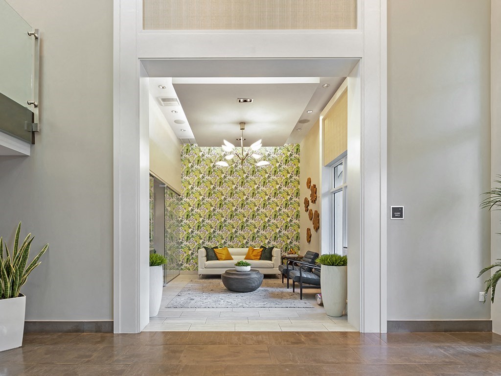 a living room with a yellow and green floral wall paper
