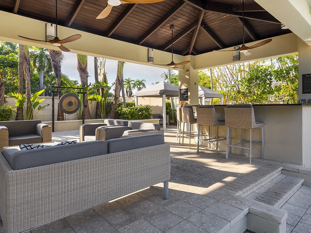 a patio with a bar and couches
