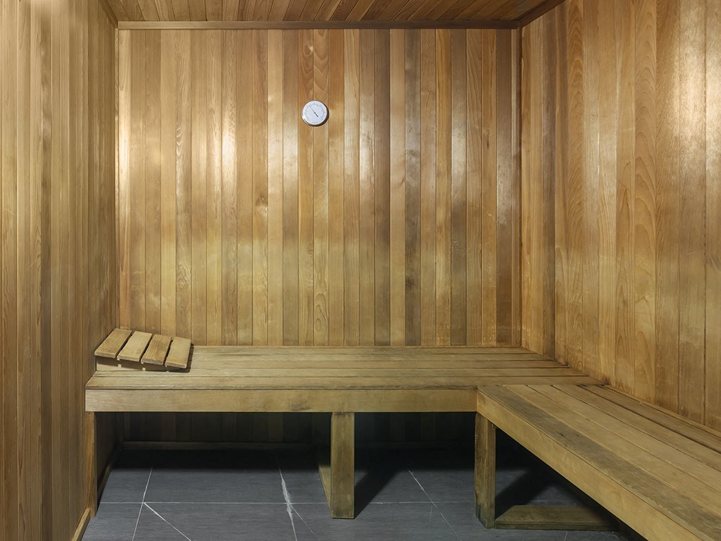 an empty sauna with wooden walls and benches