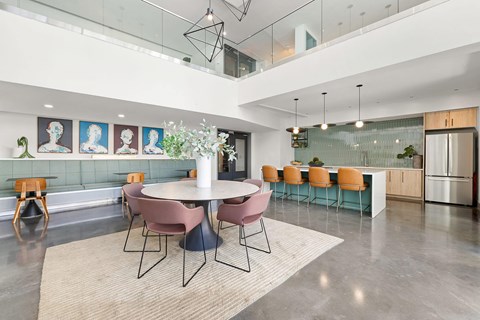 A modern dining room with a glass table and chairs.