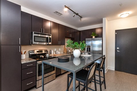 a kitchen with stainless steel appliances and a granite counter top