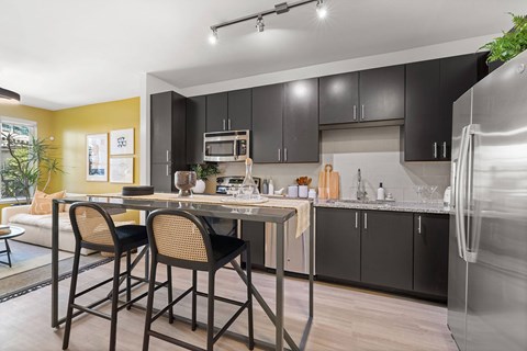 A modern kitchen with a table and chairs.