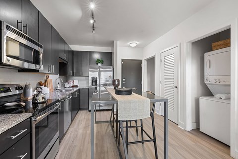 A modern kitchen with a dining table and chairs.