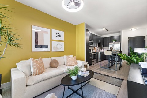 A living room with a white couch and a coffee table.