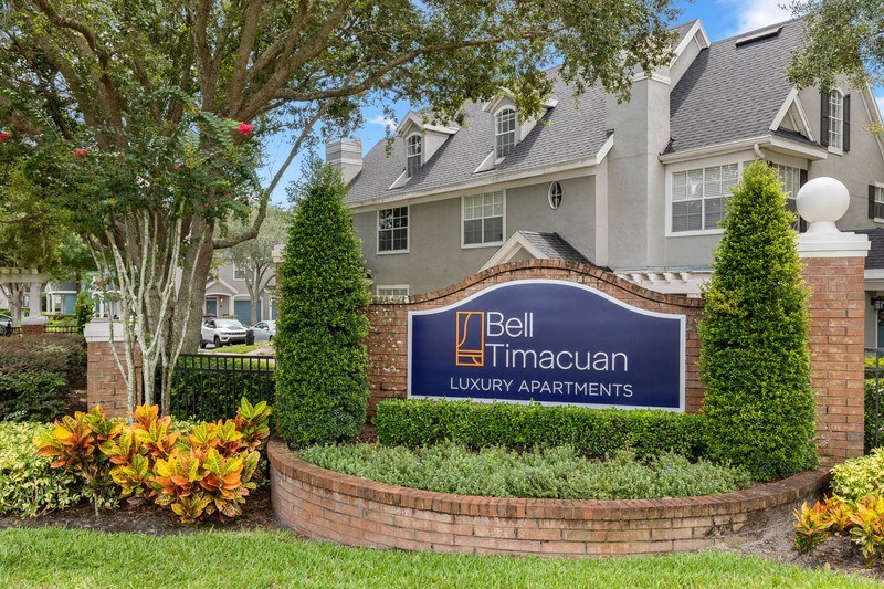 a sign in front of a large building