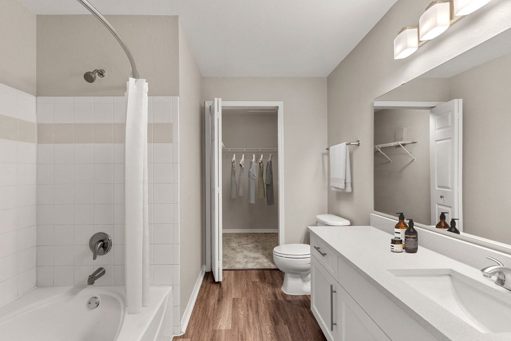 a bathroom with a shower and a sink and a toilet