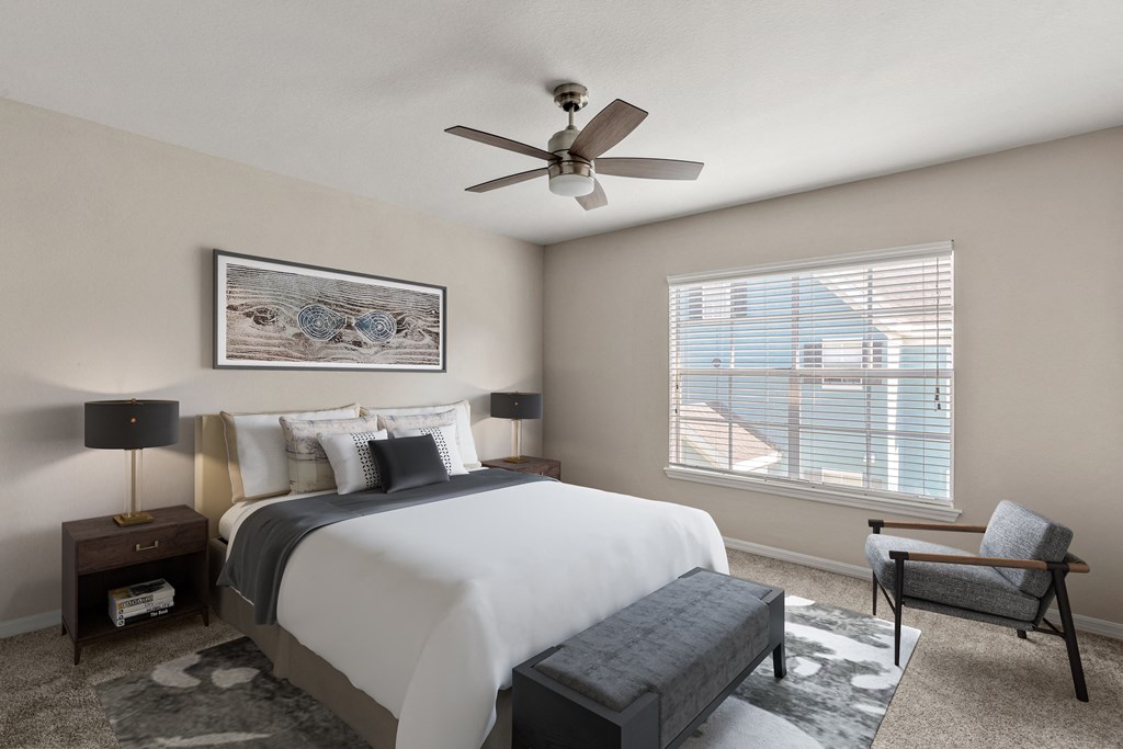 a bedroom with a large bed and a ceiling fan