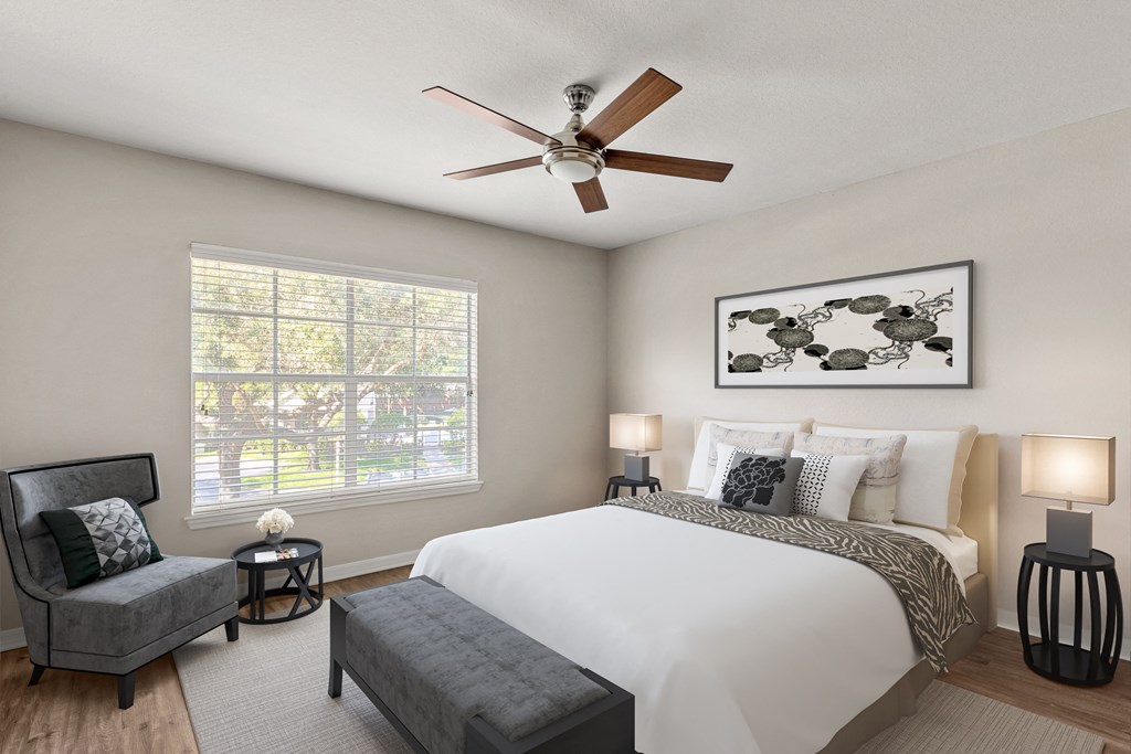 a bedroom with a large bed and a ceiling fan