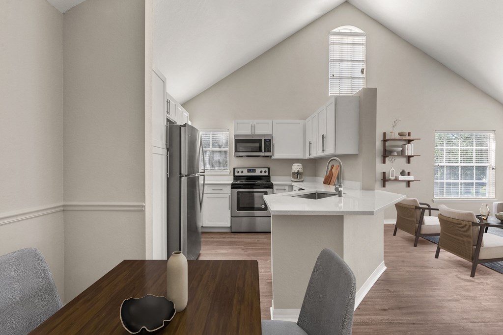 an open kitchen and dining room with a table and chairs