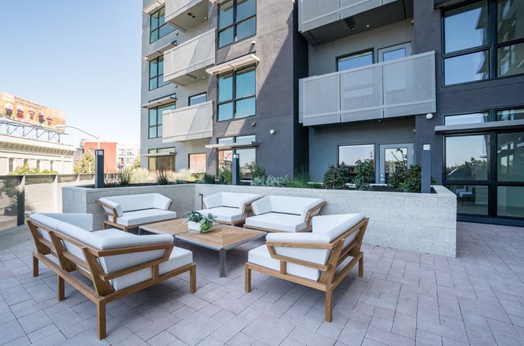 a seating area with chairs and a table on a patio