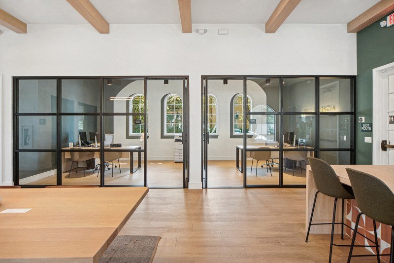 a conference room with glass doors and a table and chairs