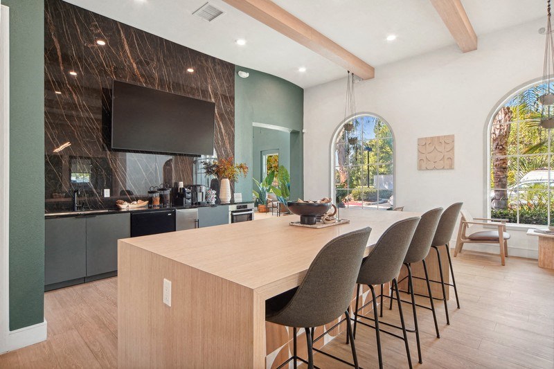 a kitchen and dining room with a wooden table and chairs