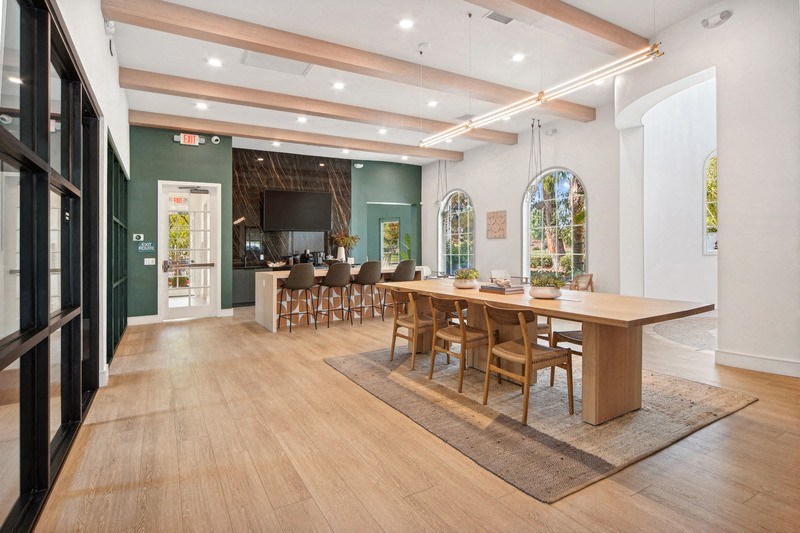 a large dining room with a large table and chairs