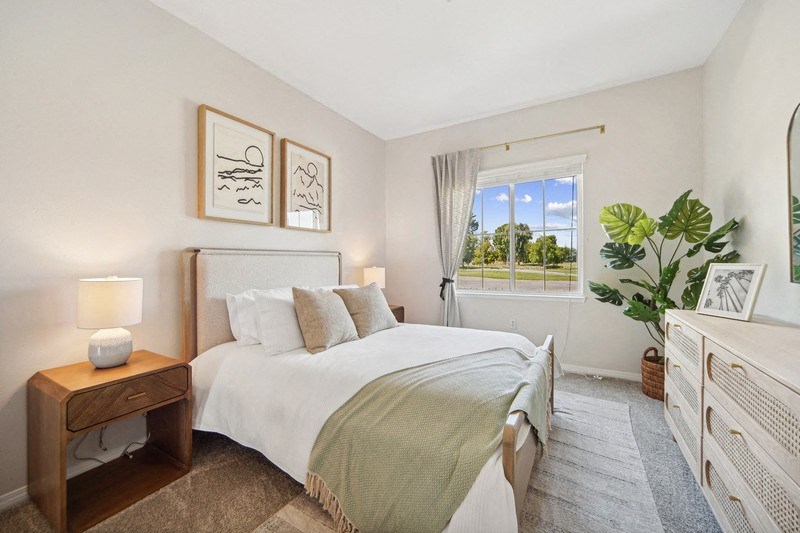 a bedroom with a large bed and a window