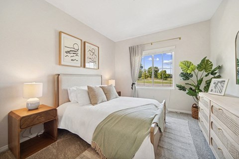 a bedroom with a large bed and a window
