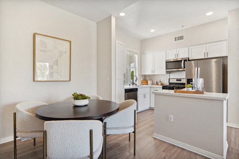 a kitchen and dining room with a table and chairs