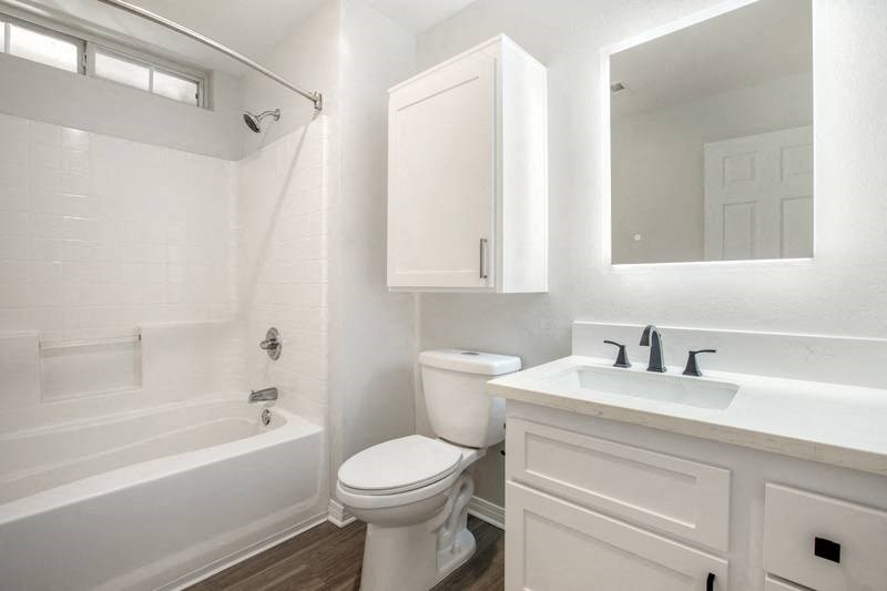 a bathroom with a sink toilet and a bath tub